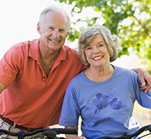 Photo of a man and woman on bicycles. 